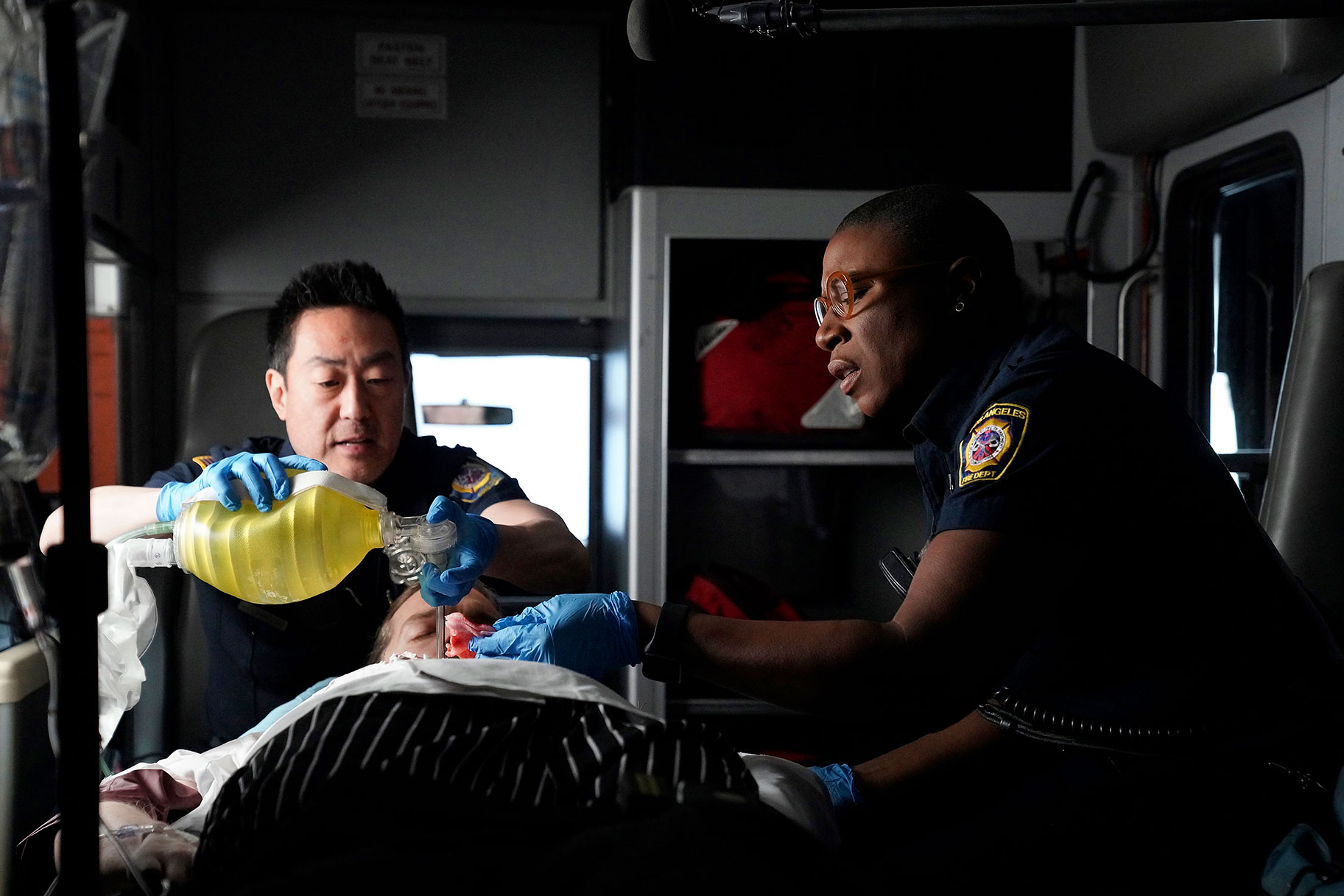 EMT's Taking Care Of Man In Ambulance
