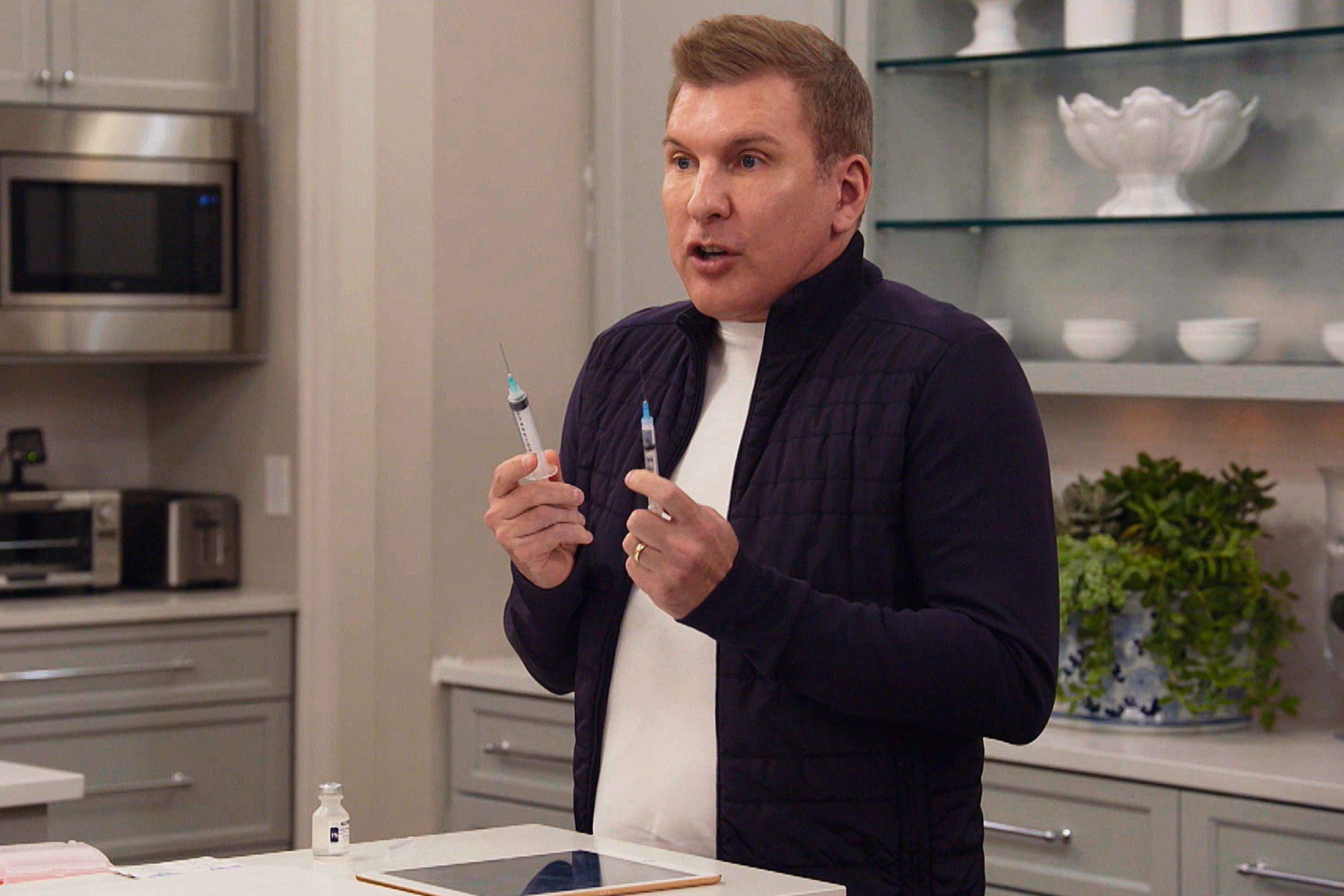 Todd Chrisley Holding A Needle In Each Hand