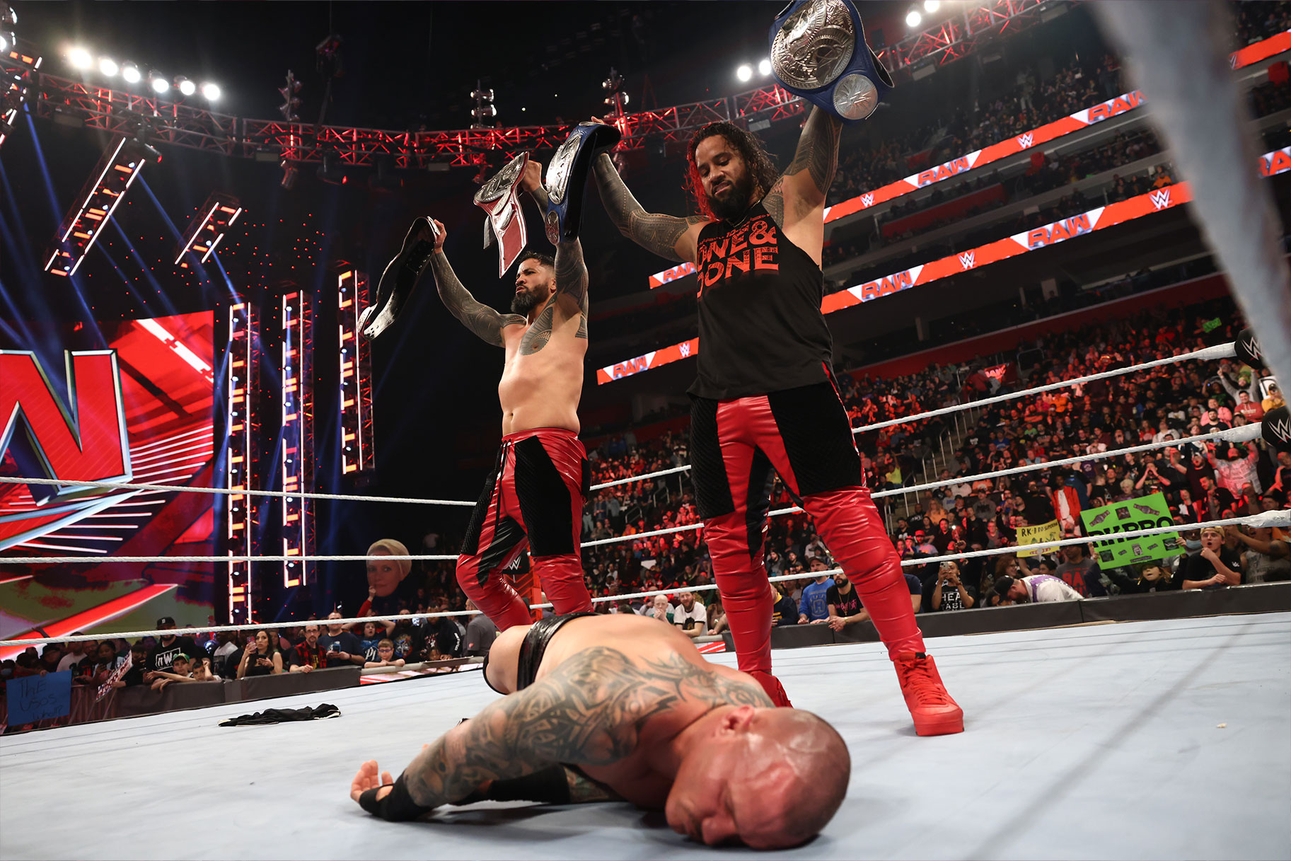 The Usos Standing Over Randy Orton