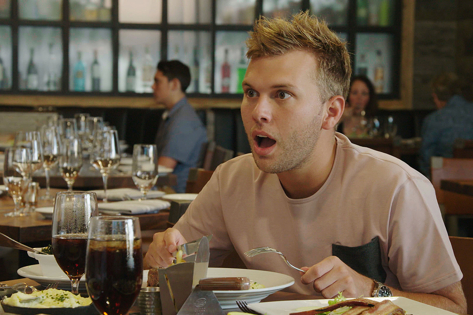 Chase Chrisley at dinner with a shocked expression on his face