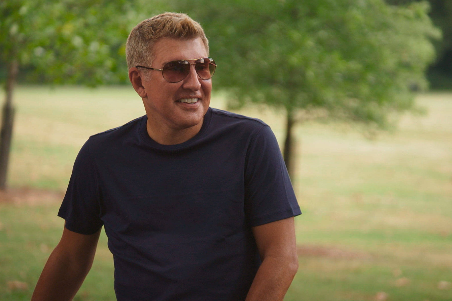 Todd Chrisley wearing sunglasses and smiling