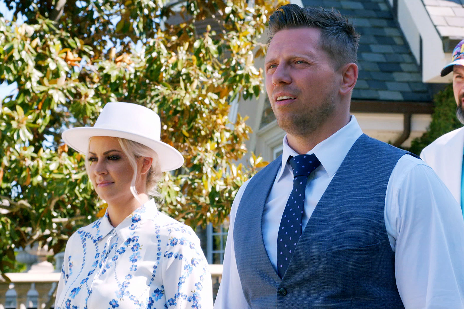 Miz and his wife standing in their backyard on a sunny day