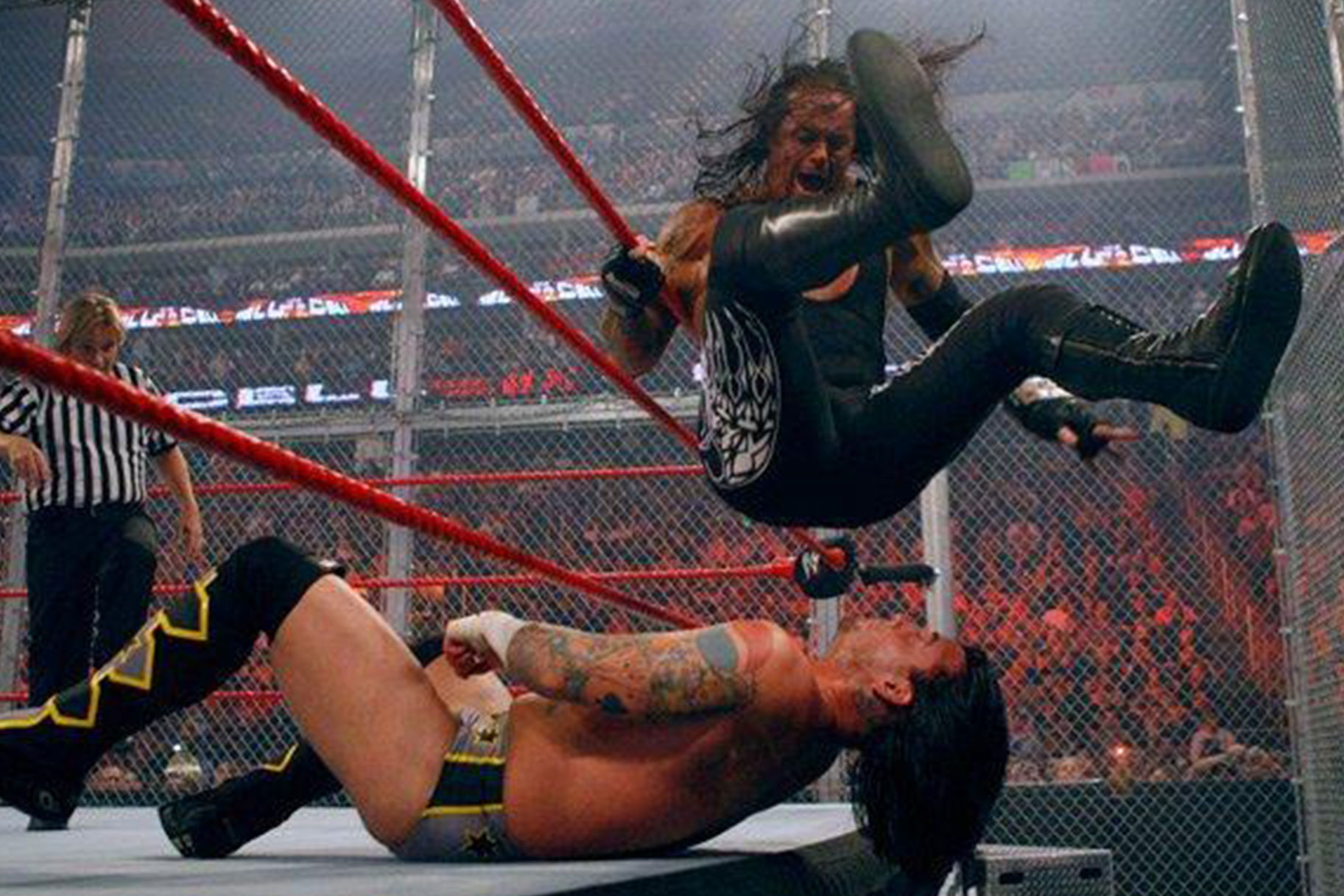 The Undertaker sitting on CMPunk in their 2005 Hell in a Cell match