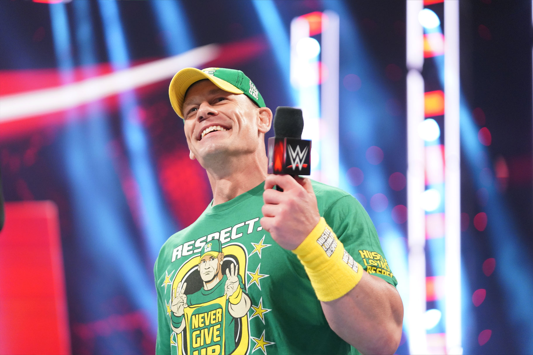 Wrestler John Cena in a green shirt and hat
