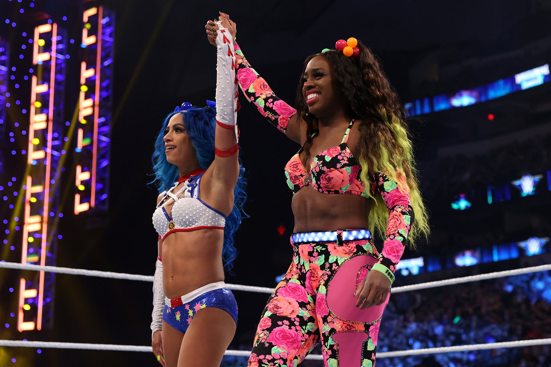 Sasha Banks and Naomi holding hands in the ring