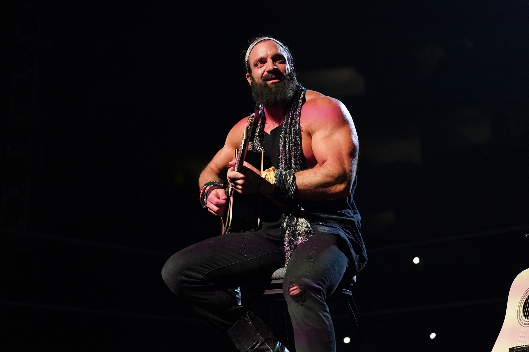 Elias playing guitar in the ring