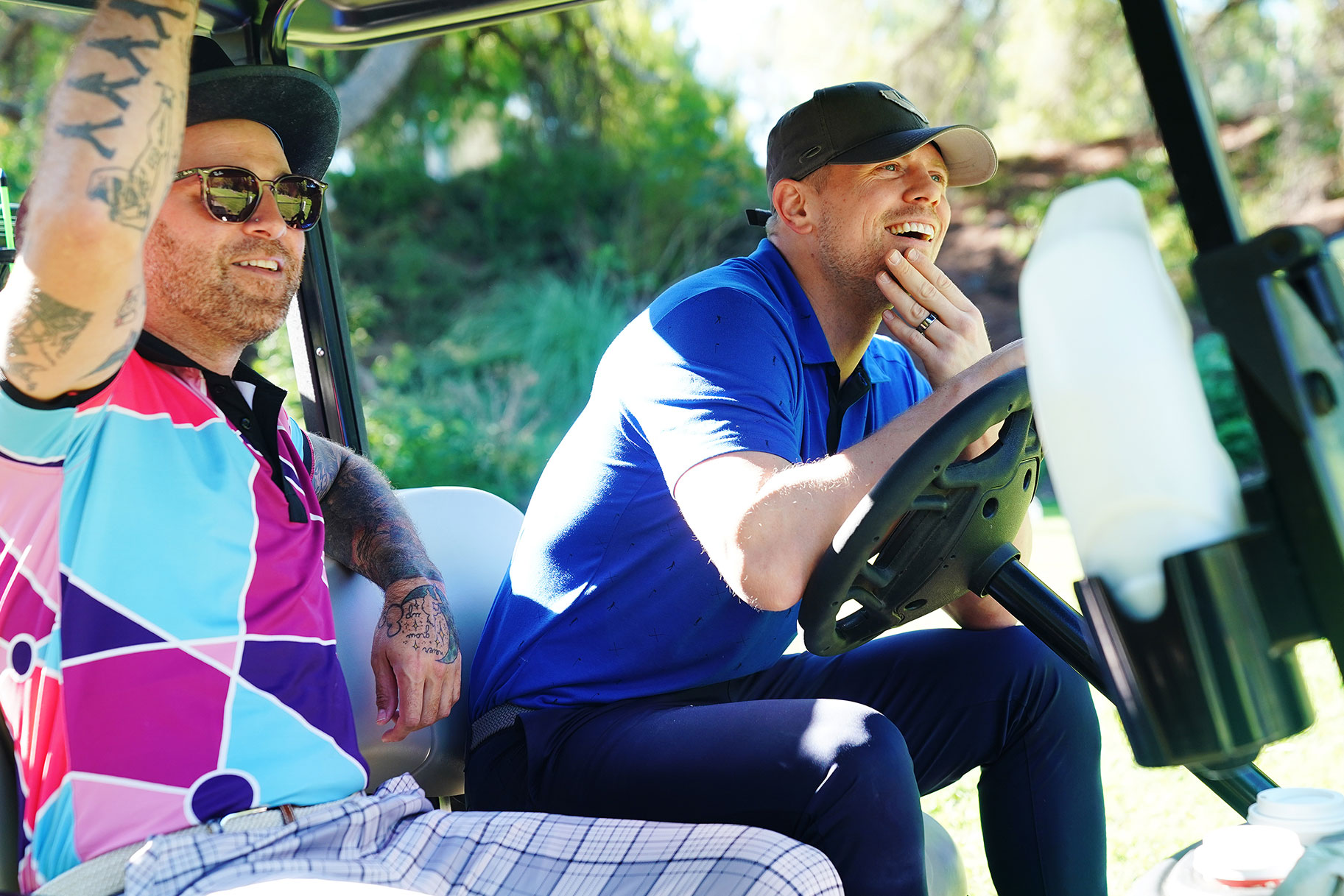Close up of the Miz and a friend riding in a golf cart