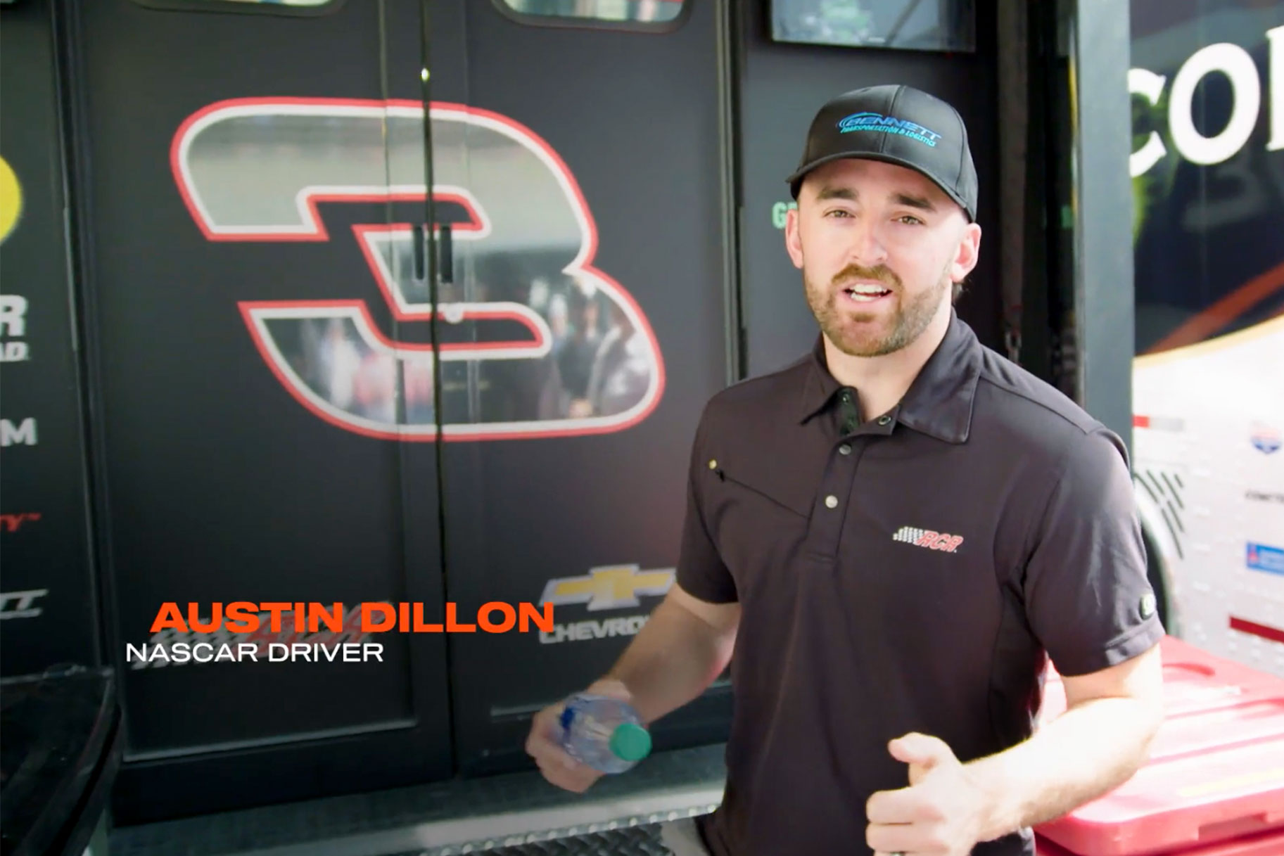 Austin Dillon standing in front of his hauler truck