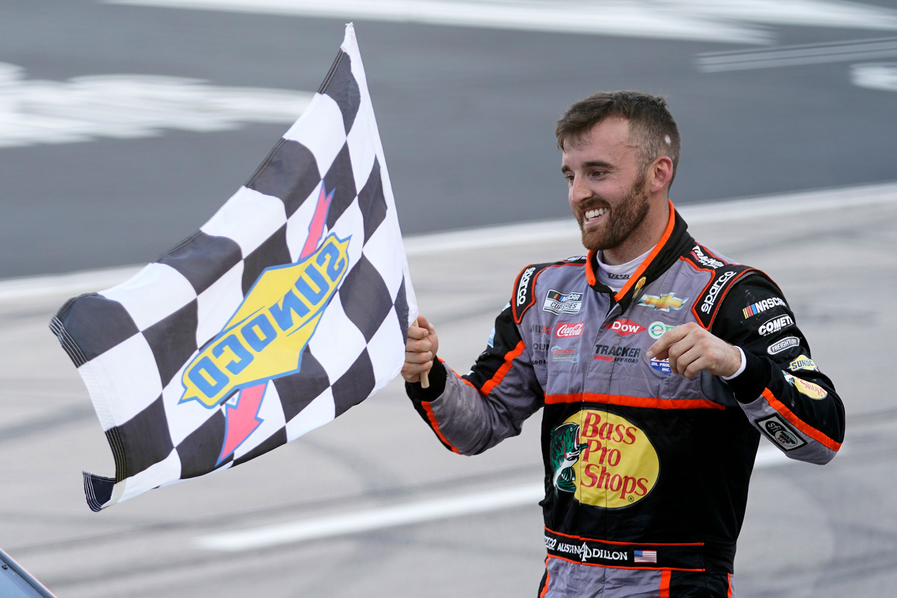 Austin Dillon celebrates with the checkered flag after winning the NASCAR Cup Series