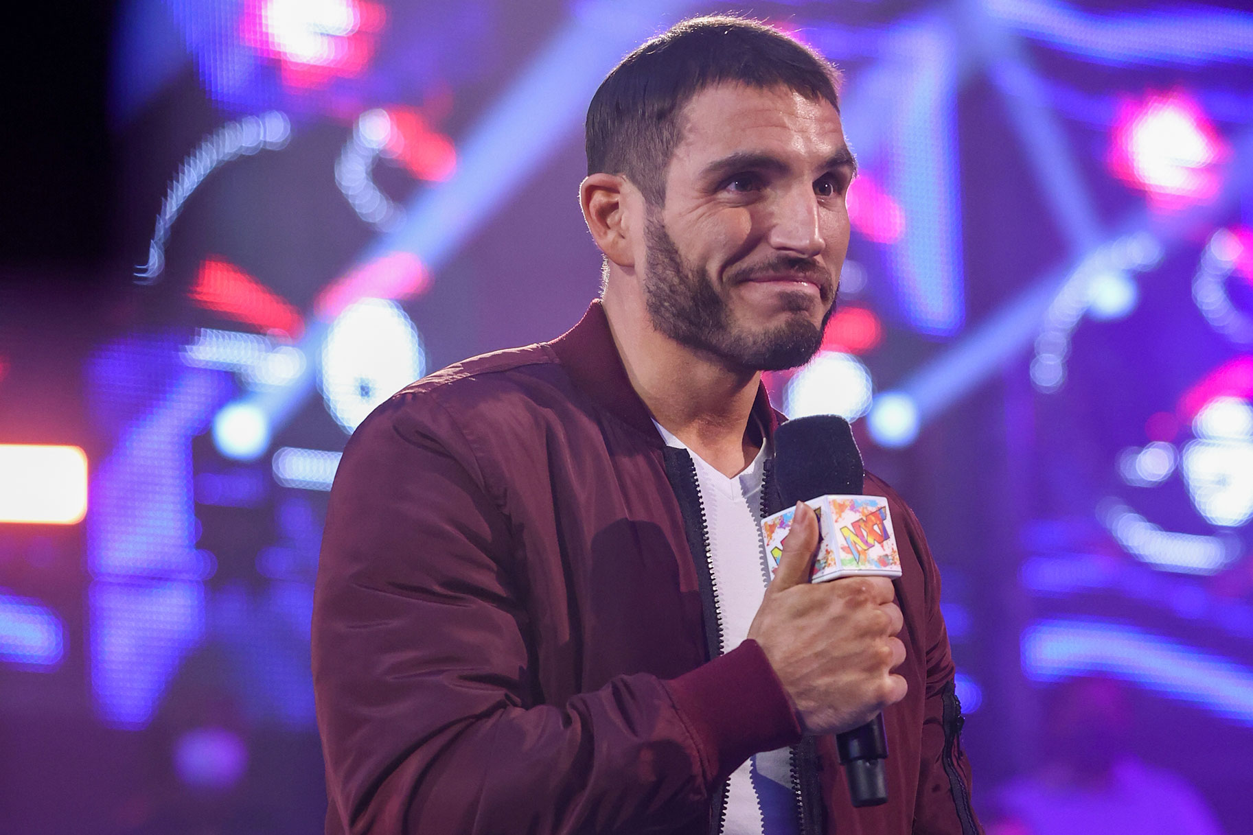 Johnny Gargano holding an NXT microphone in the ring