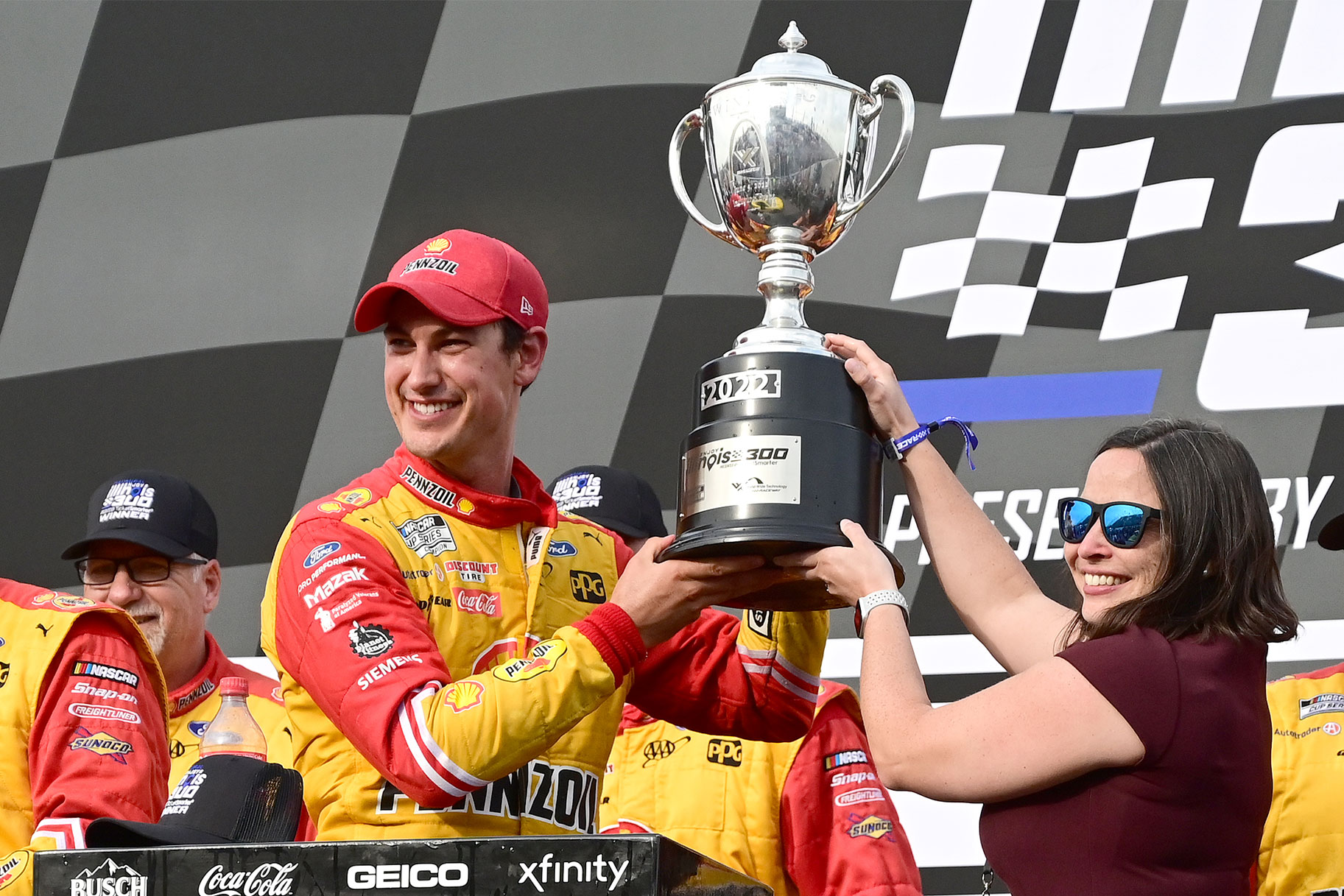 Joey Logano (#22 Team Penske Ford) is presented with the trophy after winning the inaugural NASCAR Cup Series Enjoy Illinois 300