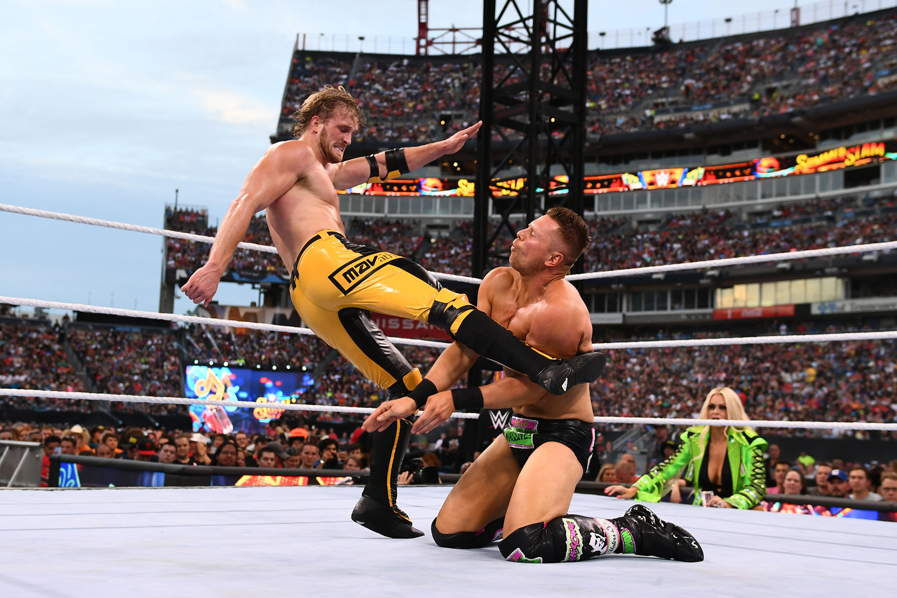 Logan Paul kicking The Miz in the ring