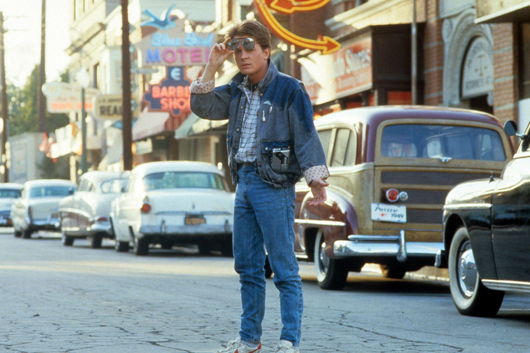Michael J. Fox walking across the street in a scene from 'Back To The Future'