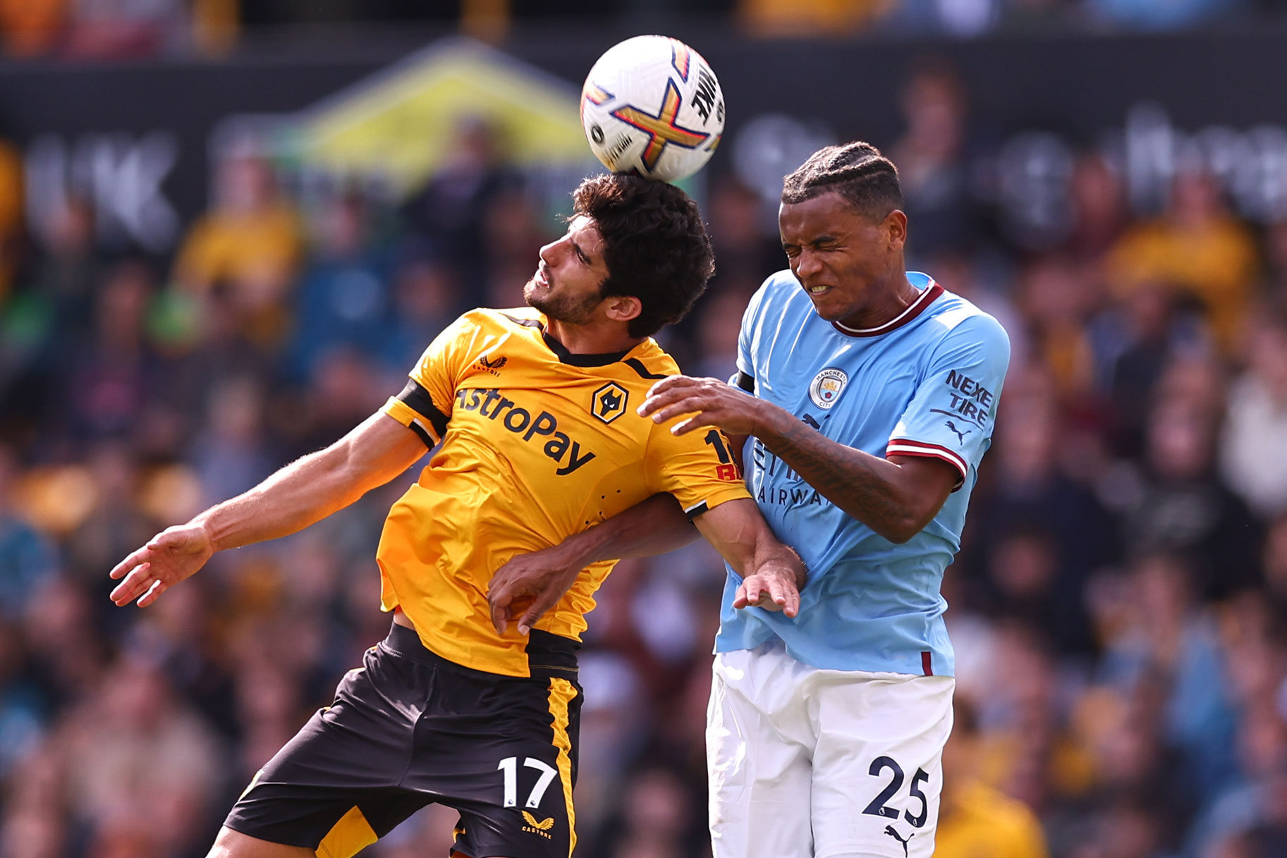 Goncalo Guedes of Wolverhampton Wanderers wins a header against Manuel Akanji of Manchester City