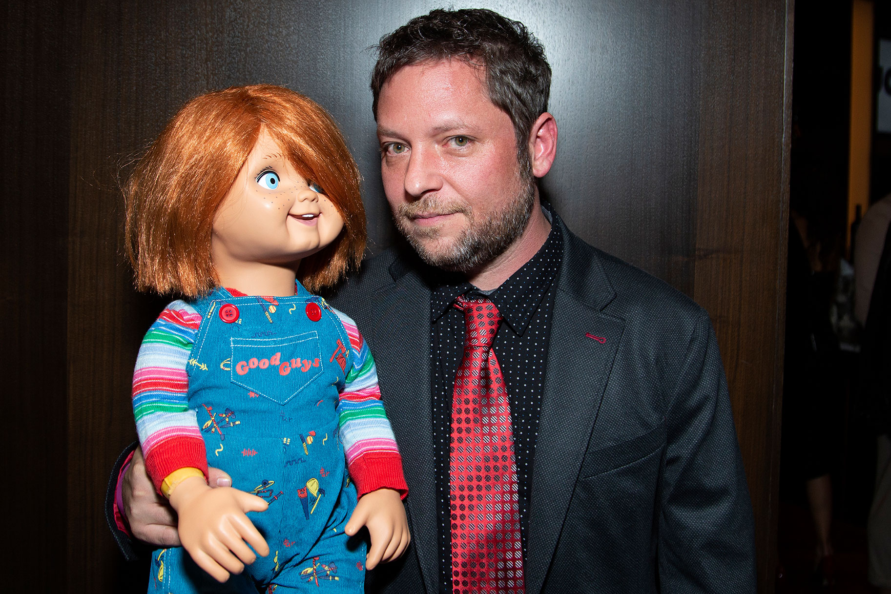Alex Vincent holding a Chucky doll