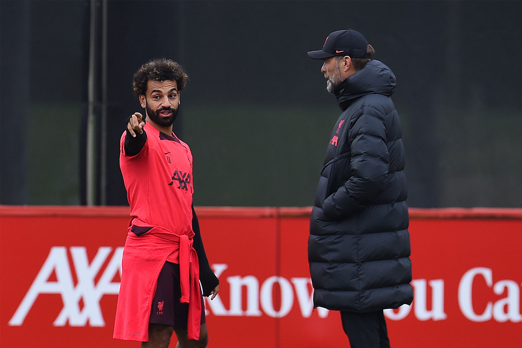 Jurgen Klopp manager of Liverpool chats with Mohamed Salah of Liverpool during a training session