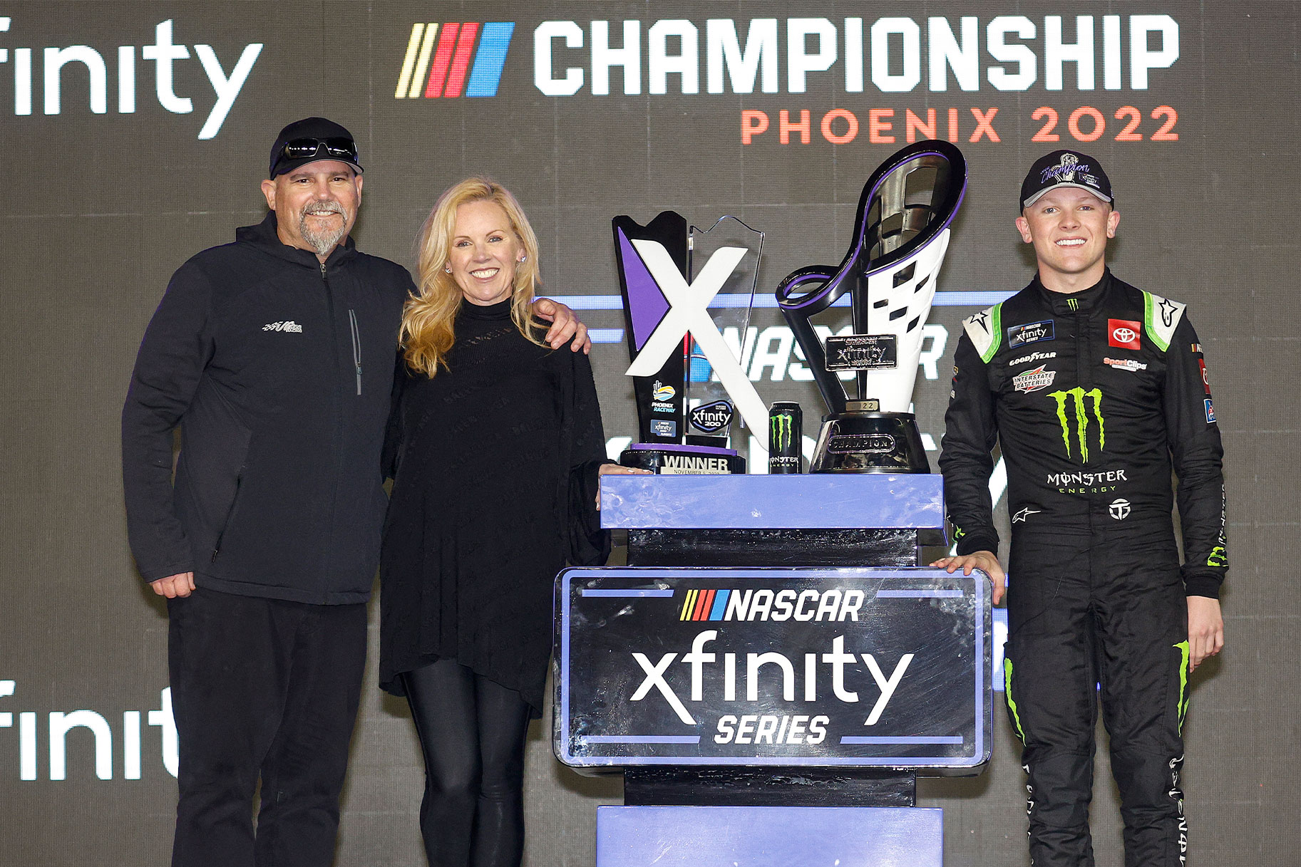 Ty Gibbs celebrates with his father, Coy Gibbs and mother, Heather Gibbs in victory lane after winning the NASCAR Xfinity Series Championship
