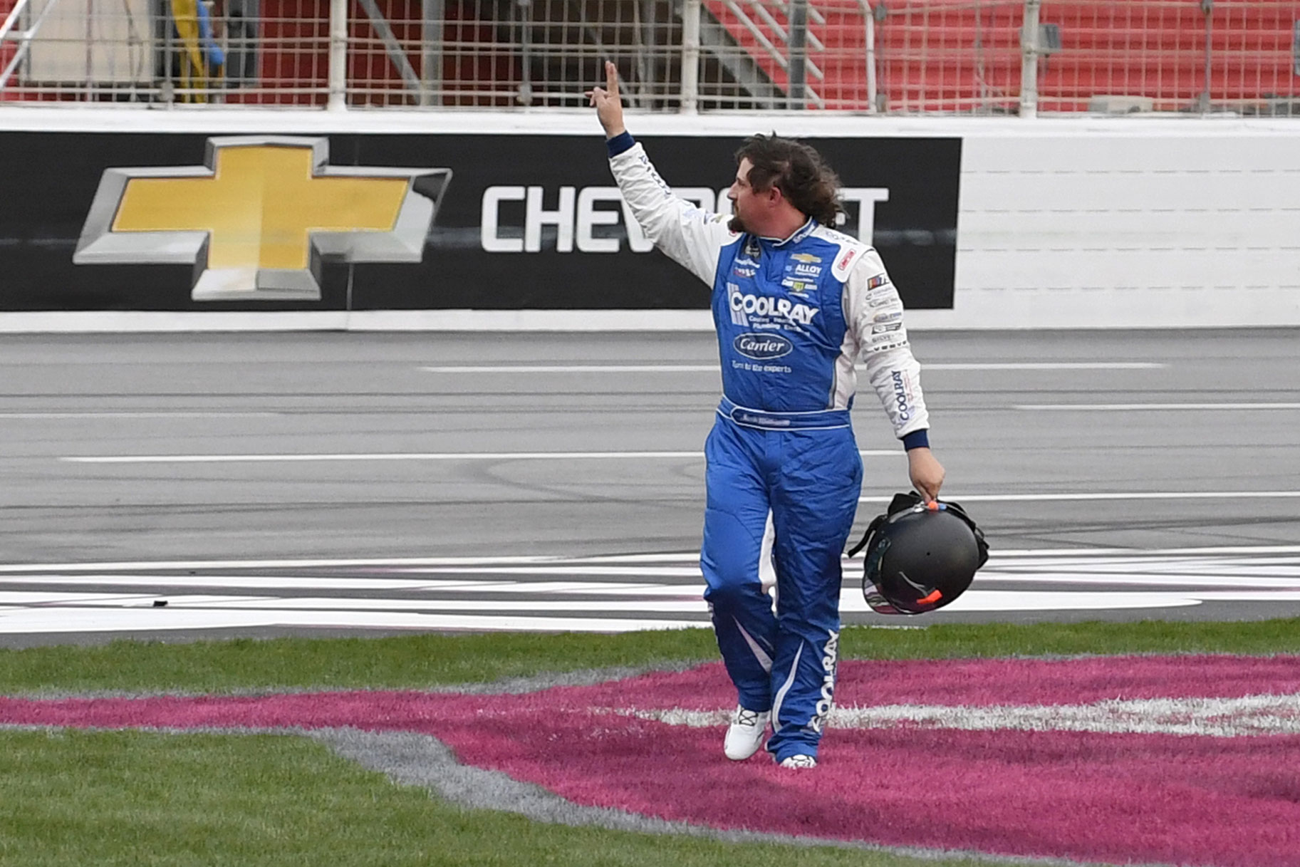 Nascar driver Josh Williams waving to the crowd at a race