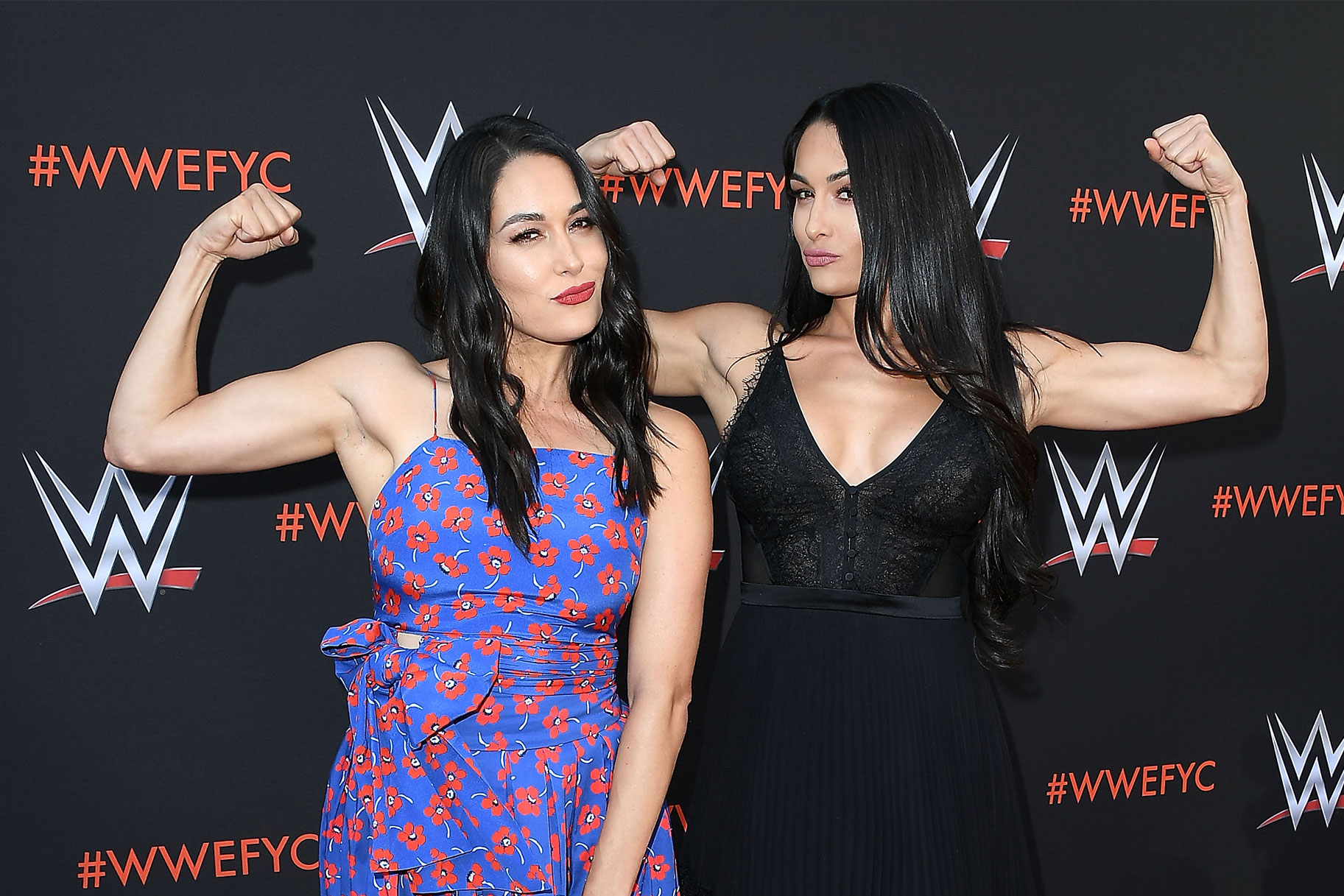 Bella Twins flexing their muscles on a WWE red carpet