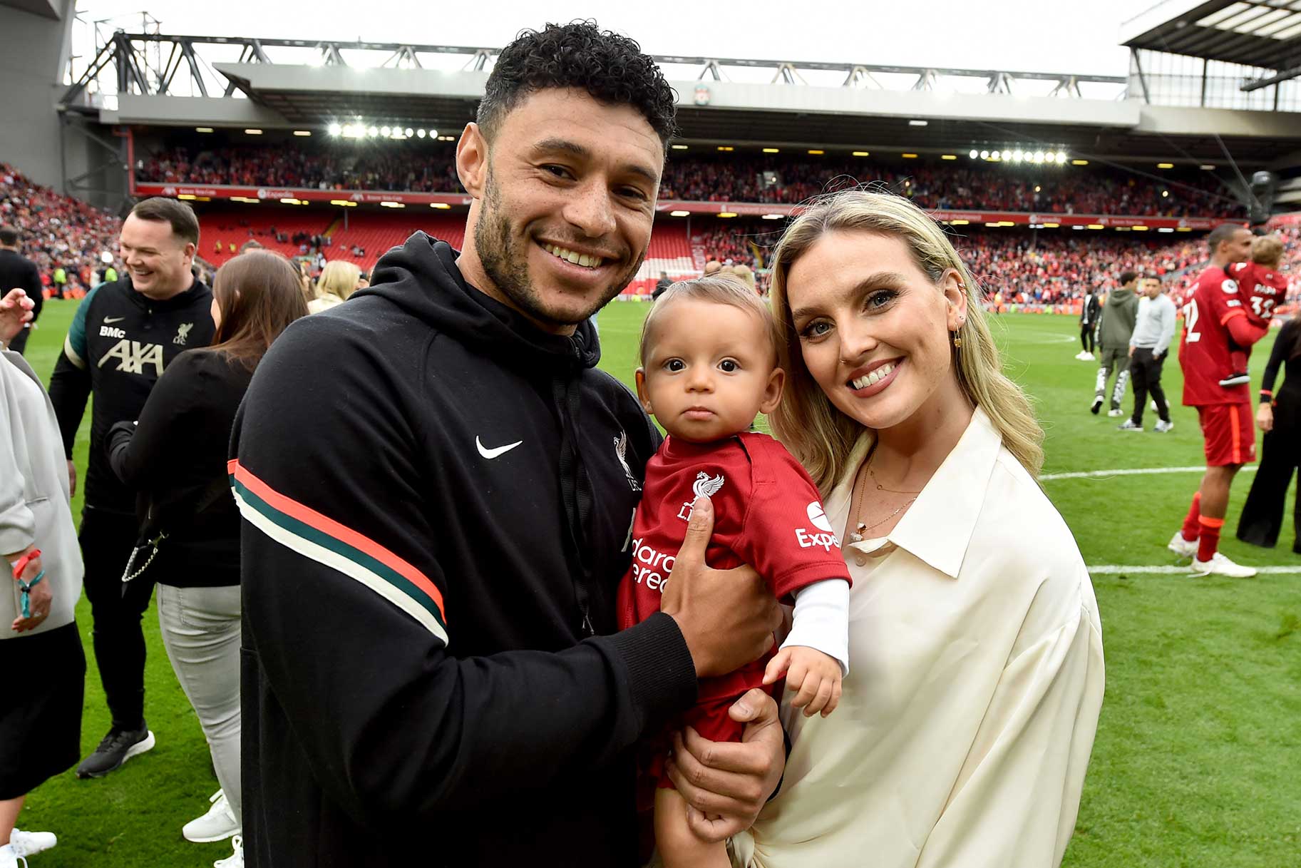 Alex Oxlade-Chamberlain of Liverpool posing for a photograph with Perrie Edwards and their baby boy at the end of the Premier League match between Liverpool and Wolverhampton Wanderers