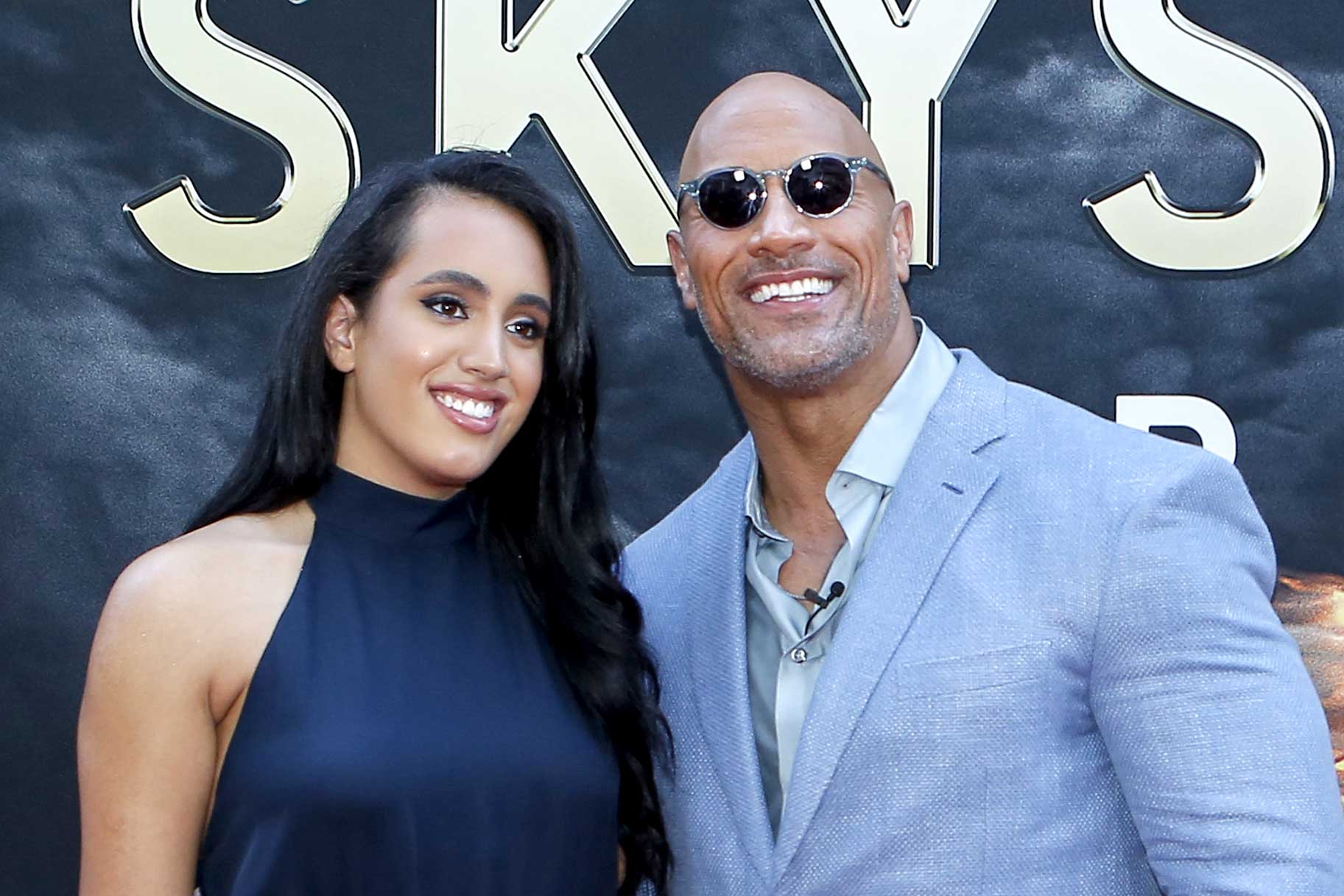 Dwayne Johnson and daughter Simone Alexandra Johnson smile for the cameras at the premiere of Skyscraper