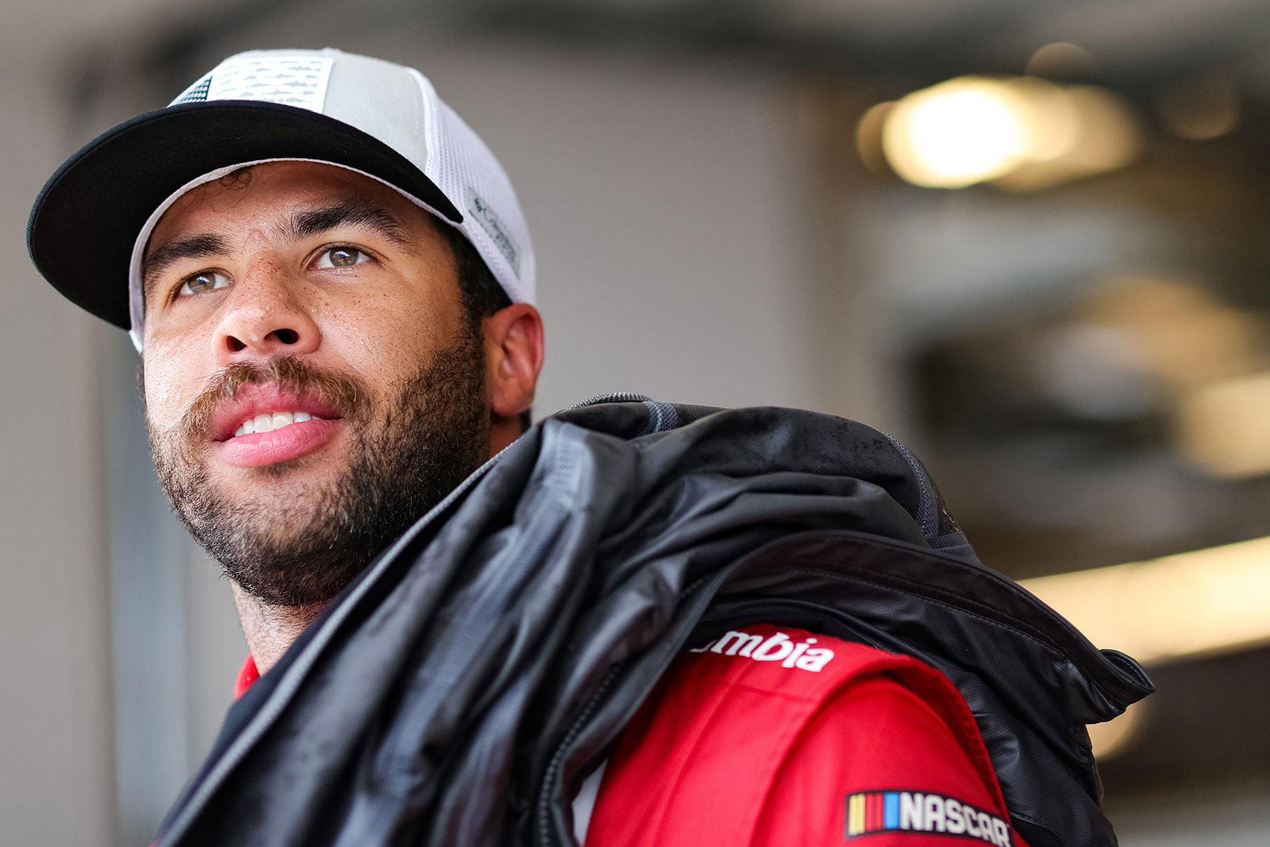 Bubba Wallace, driver of the #23 DoorDash Toyota, waits in the garage area during practice for the NASCAR Cup Series EchoPark Texas Grand at Circuit of The Americas
