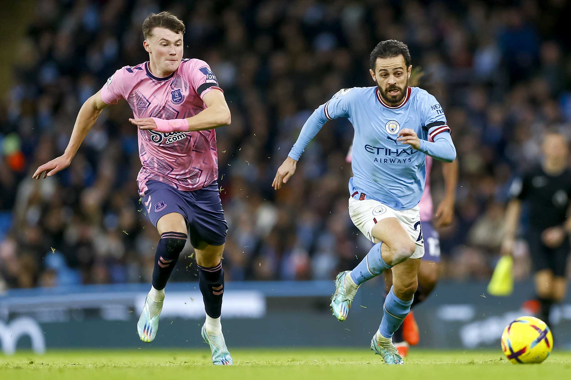 Soccer players Nathan Patterson and Bernardo Silva on the field during a Premier League match
