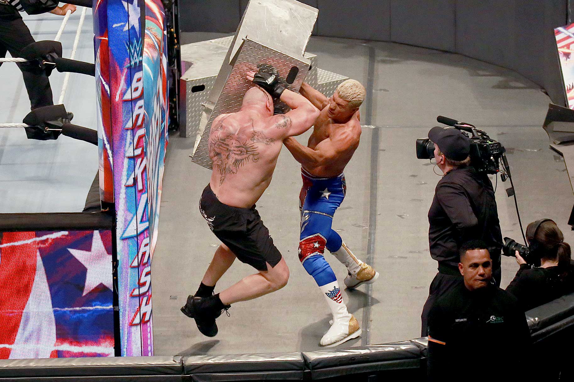 Cody Rhodes and Brock Lesnar fight each other outside the ring