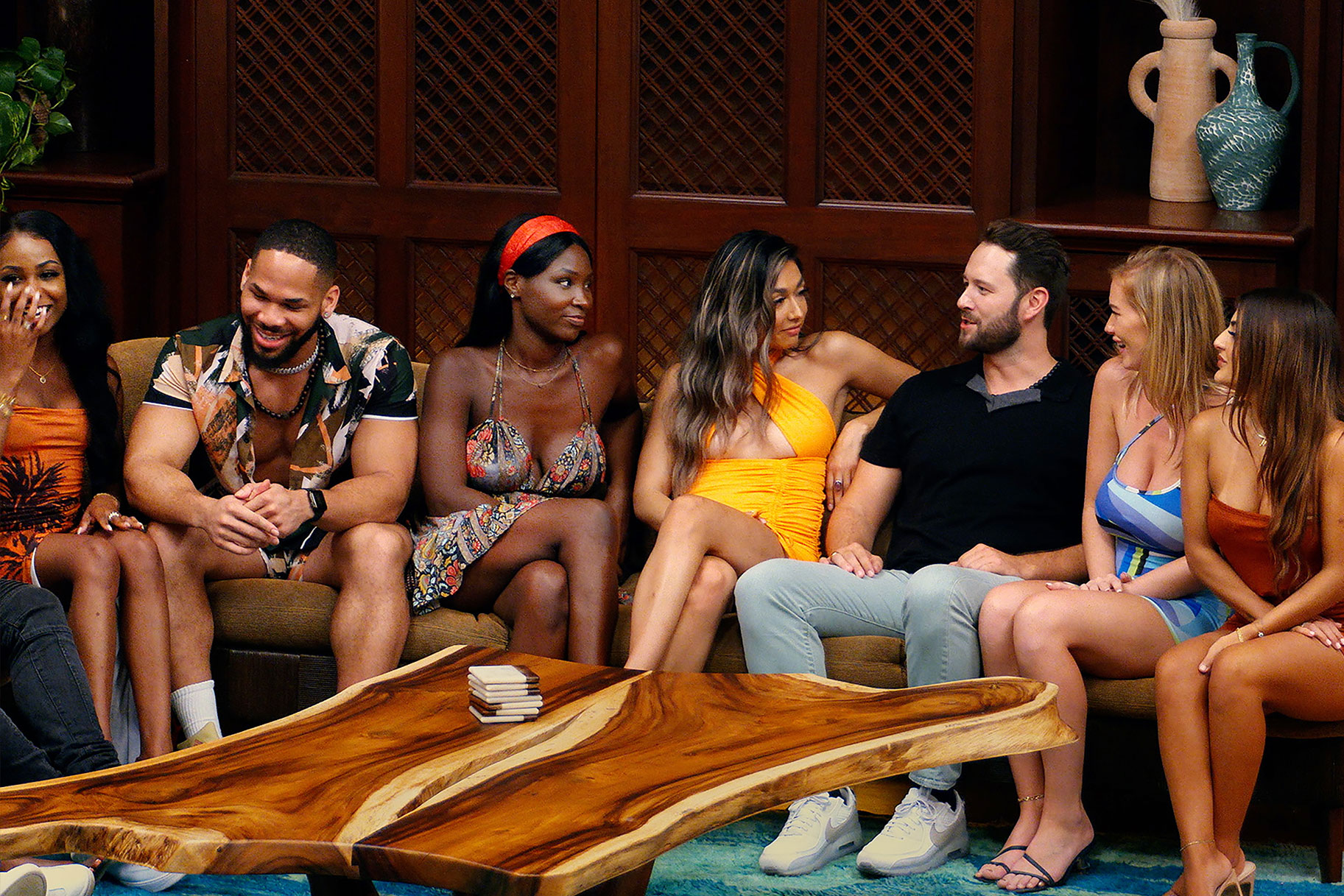 Six Temptation Island Singles congregated on a couch
