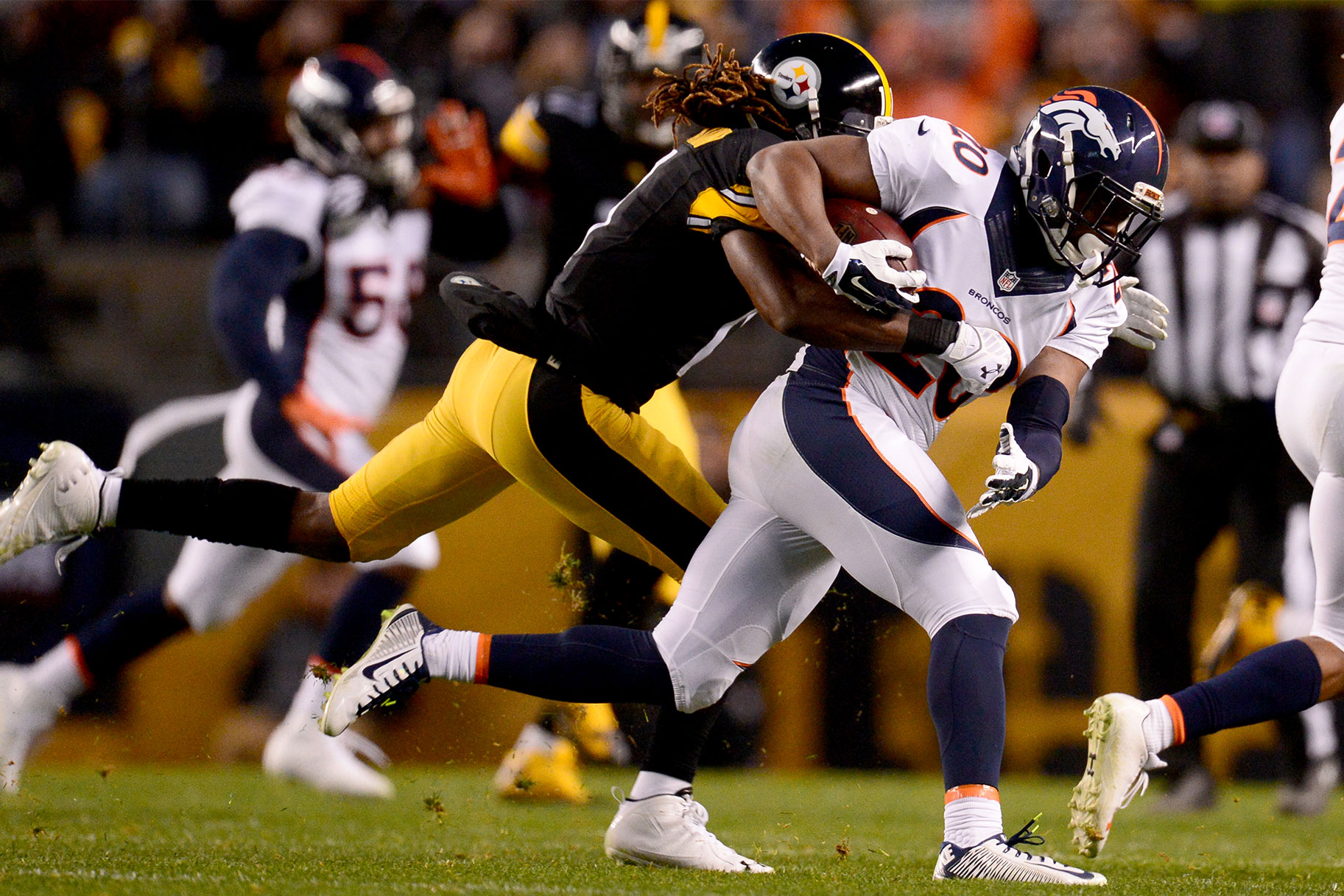 Markus Wheaton of the Pittsburgh Steelers stops Josh Bush of the Denver Broncos after an interception during the first half of play at Heinz Field.