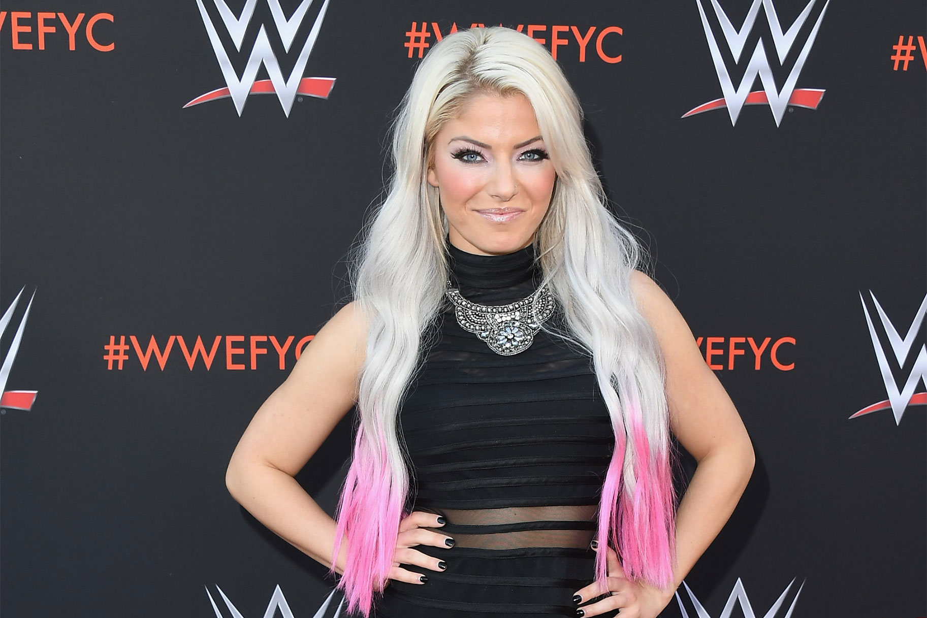 Alexa Bliss poses on the red carpet of a WWE event