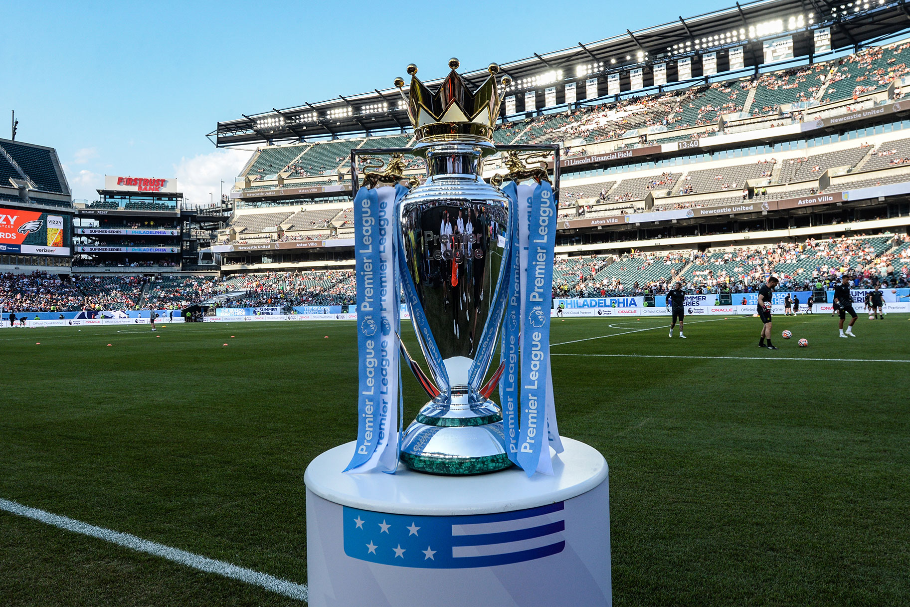 The premier league trophy sits on a column on the field