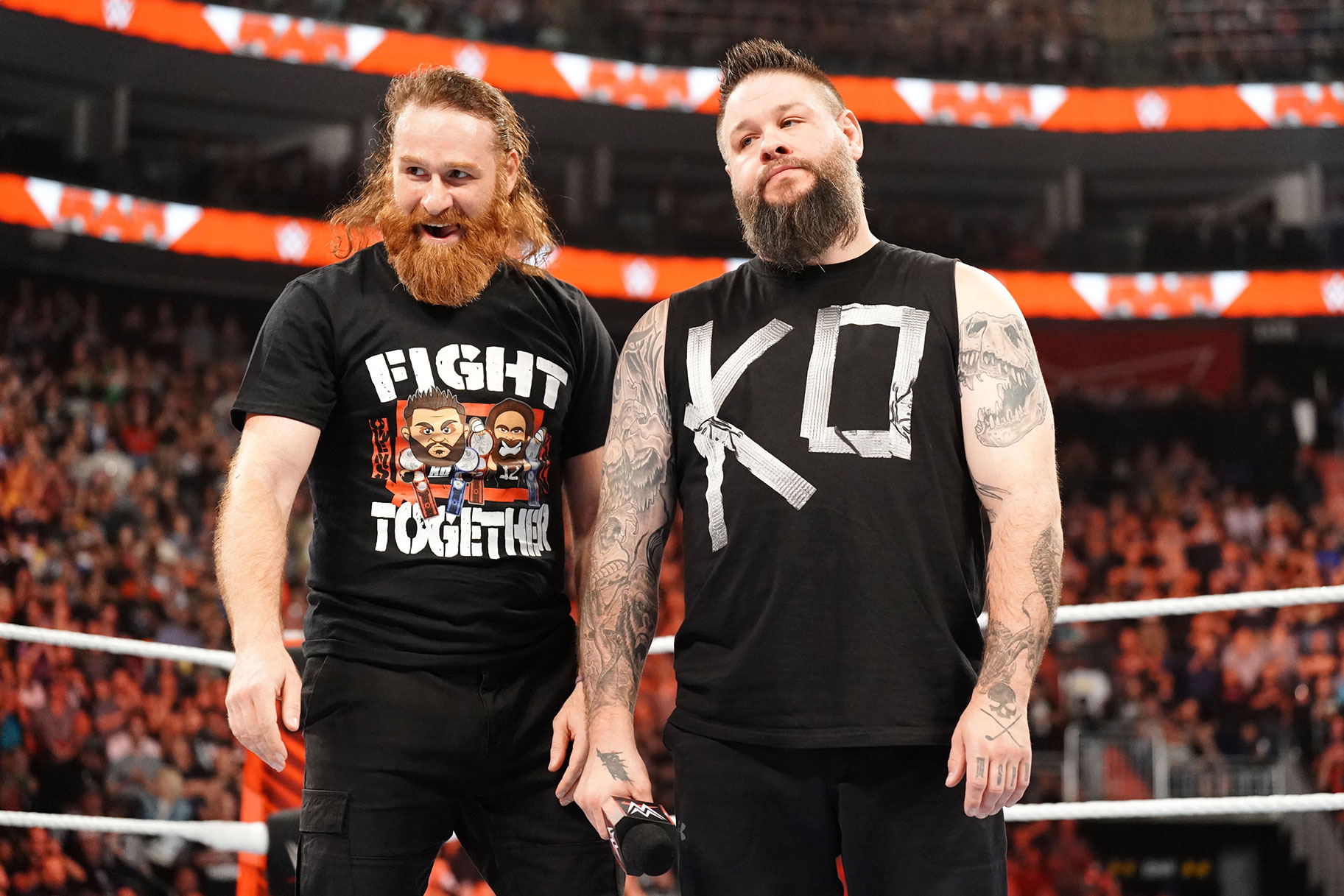 Kevin Owens and Sami Zayn stand in the ring together