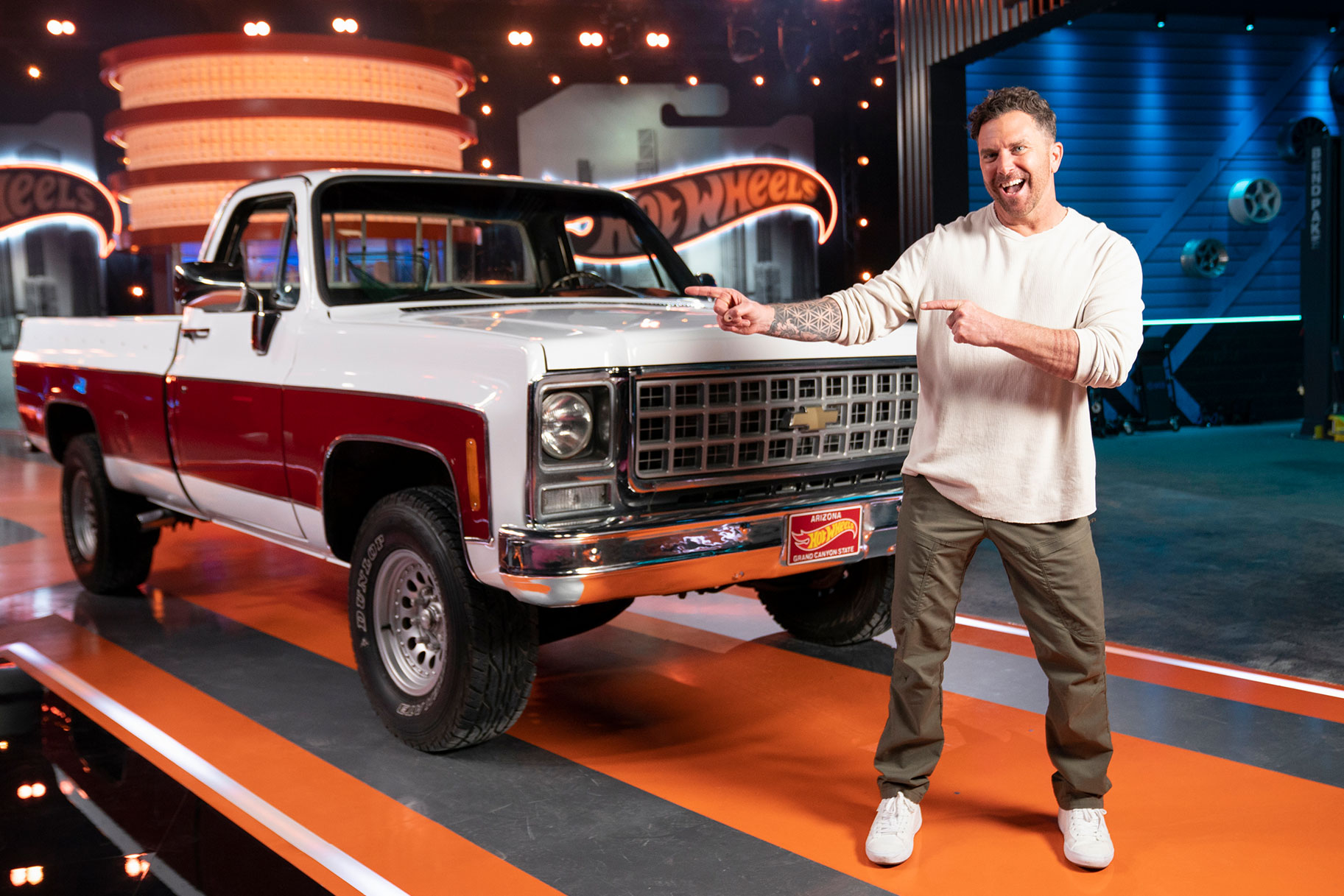 Hot Wheels Episode Winner stands in front of his white and red truck