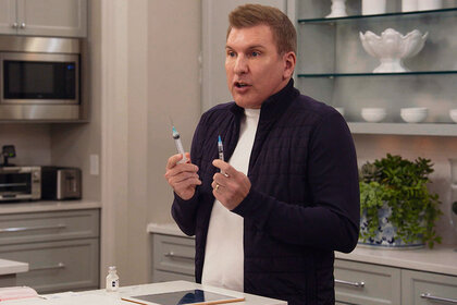 Todd Chrisley Holding A Needle In Each Hand