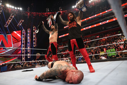 The Usos Standing Over Randy Orton