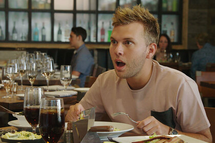 Chase Chrisley at dinner with a shocked expression on his face