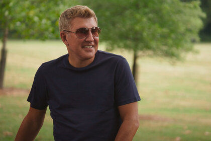 Todd Chrisley wearing sunglasses and smiling