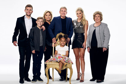 The Chrisleys standing in front of a white backdrop
