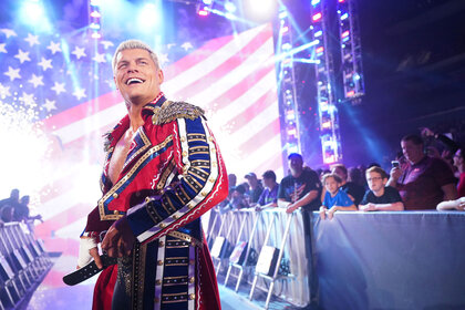 Cody Rhodes adjusting his belt outside of the ring