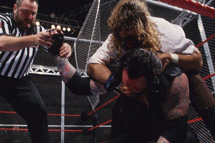 Mick Foley putting The Undertaker in a headlock during their 1997 Hell In A Cell match