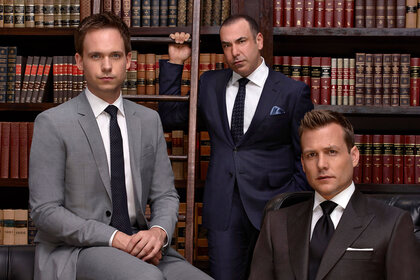 Mike Ross (Patrick J. Adams), Louis Litt (Rick Hoffman), and Harvey Specter (Gabriel Macht) appear in a promotional image for Season 4 of Suits