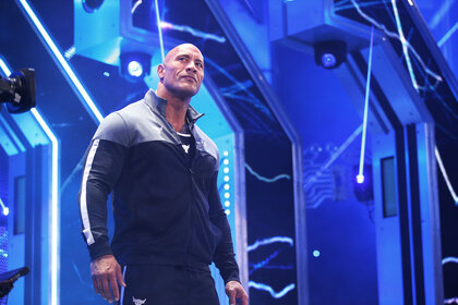 The Rock walking to the ring