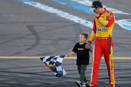 Joey Logano celebrates with his son, Hudson after winning the 2022 NASCAR Cup Series Championship