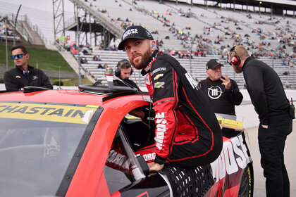 Ross Chastain, driver of the #1 Moose Fraternity Chevrolet, enters his car during qualifying for the NASCAR Cup Series Xfinity 500 at Martinsville Speedway