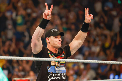 John Cena throwing up the peace sign while in the ring
