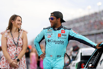 Bubba Wallace, driver of the #23 Columbia PFG Toyota, and fiance Amanda Carter talk on the grid prior to the NASCAR Cup Series Coke Zero Sugar 400 at Daytona International Speedwa