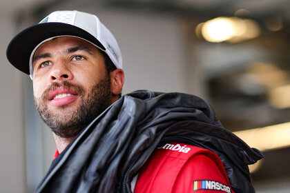 Bubba Wallace, driver of the #23 DoorDash Toyota, waits in the garage area during practice for the NASCAR Cup Series EchoPark Texas Grand at Circuit of The Americas