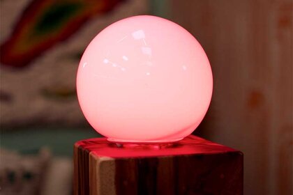 A round light that glows red in the living room of the Temptation Island house