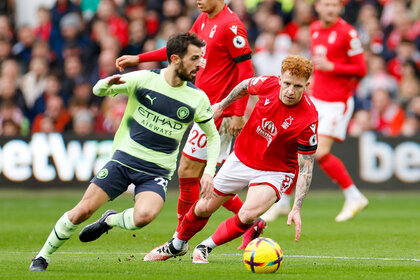 Bernardo Silva of Manchester City tracked by Jack Colback of Nottingham Forest during a match